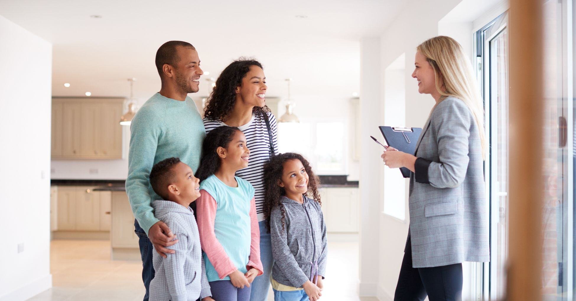 Family looking at home with realtor